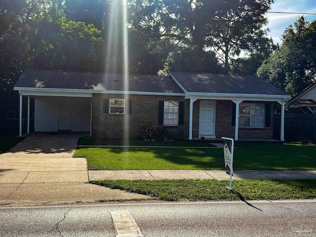 6255 Memphis Ave, Pensacola, FL 32526 - ranch-style house featuring brick siding, a front lawn, concrete driveway, and a carport