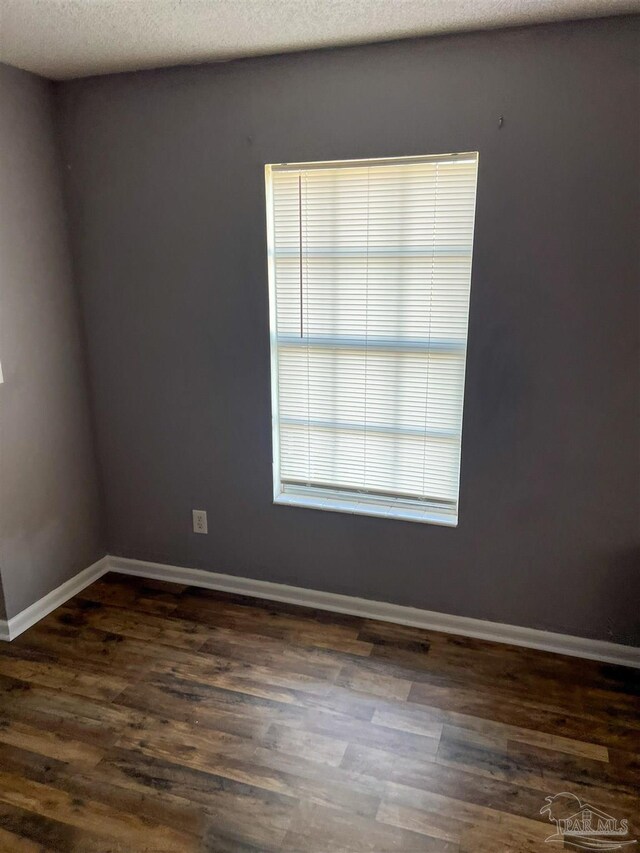 6255 Memphis Ave, Pensacola, FL 32526 - unfurnished room with dark wood-style flooring and baseboards