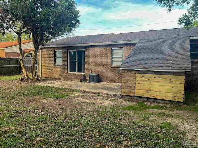 6255 Memphis Ave, Pensacola, FL 32526 - rear view of house featuring fence, roof with shingles, a patio, brick siding, and central air condition unit