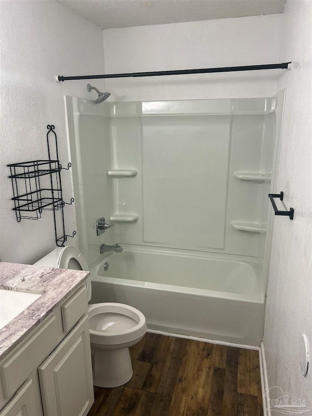 6255 Memphis Ave, Pensacola, FL 32526 - bathroom featuring wood finished floors, a textured wall, bathing tub / shower combination, vanity, and toilet