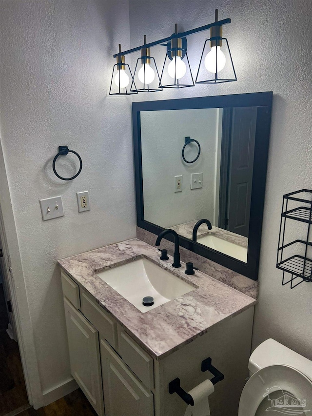 6255 Memphis Ave, Pensacola, FL 32526 - bathroom featuring vanity, a textured wall, and toilet