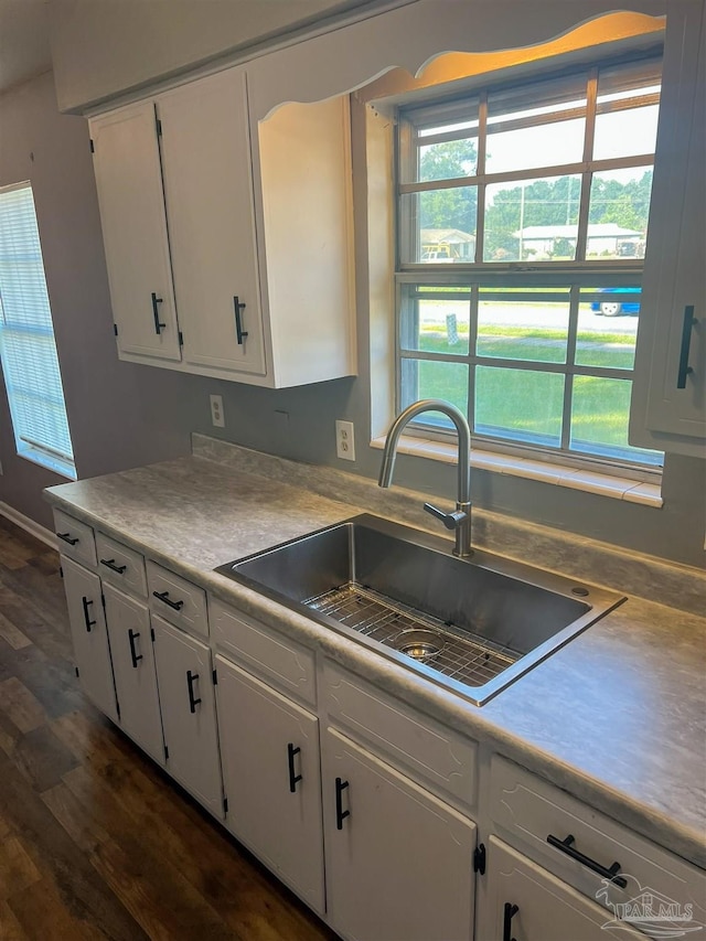 6255 Memphis Ave, Pensacola, FL 32526 - kitchen featuring a sink, white cabinets, and dark wood-style floors