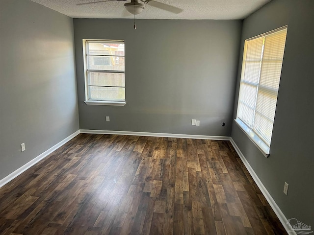 6255 Memphis Ave, Pensacola, FL 32526 - spare room featuring a ceiling fan, healthy amount of natural light, a textured ceiling, dark wood-style flooring, and baseboards