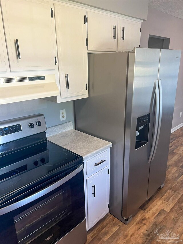 6255 Memphis Ave, Pensacola, FL 32526 - kitchen featuring stainless steel appliances, under cabinet range hood, light countertops, dark wood-style floors, and white cabinetry