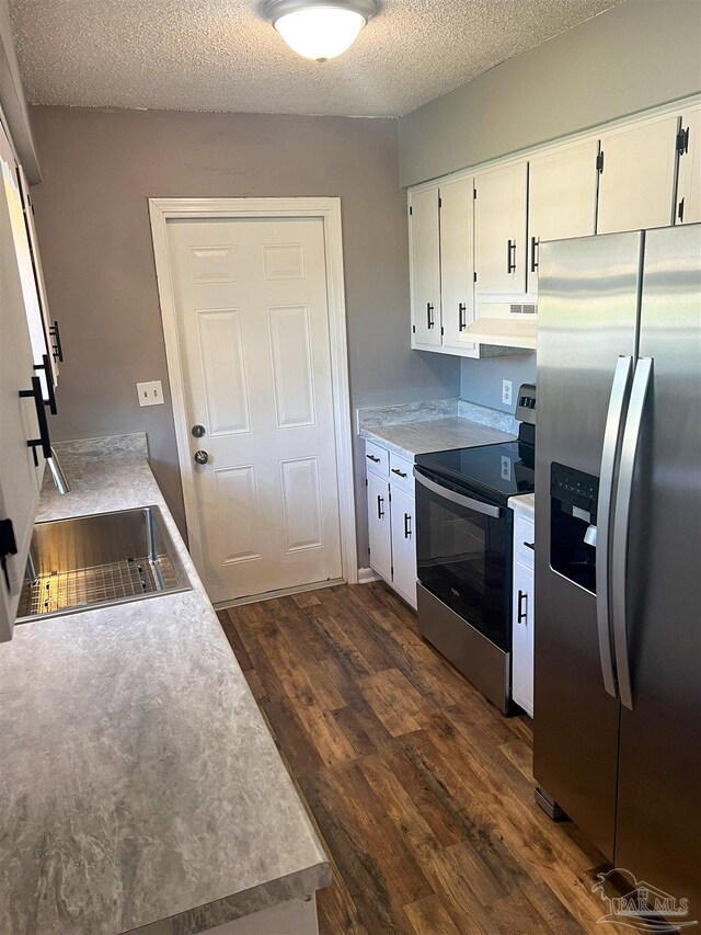6255 Memphis Ave, Pensacola, FL 32526 - kitchen with appliances with stainless steel finishes, dark wood-style floors, under cabinet range hood, white cabinets, and a textured ceiling