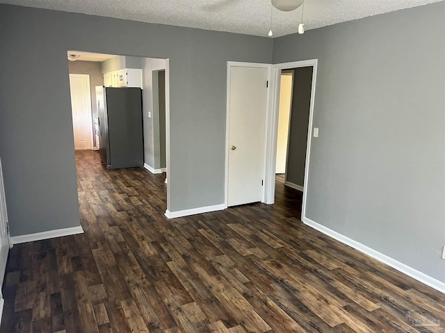 6255 Memphis Ave, Pensacola, FL 32526 - spare room featuring dark wood-style floors, a textured ceiling, and baseboards
