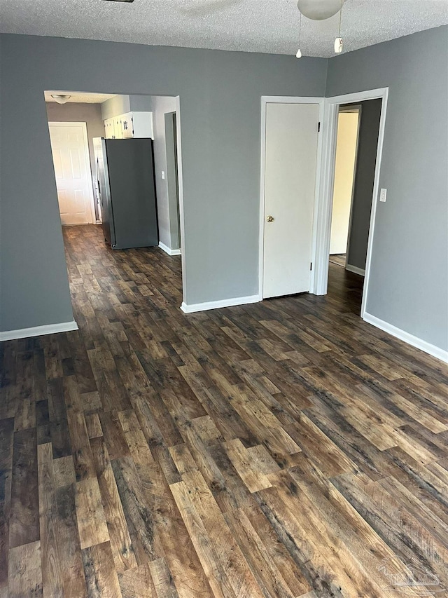 6255 Memphis Ave, Pensacola, FL 32526 - empty room with dark wood finished floors, a textured ceiling, baseboards, and a ceiling fan