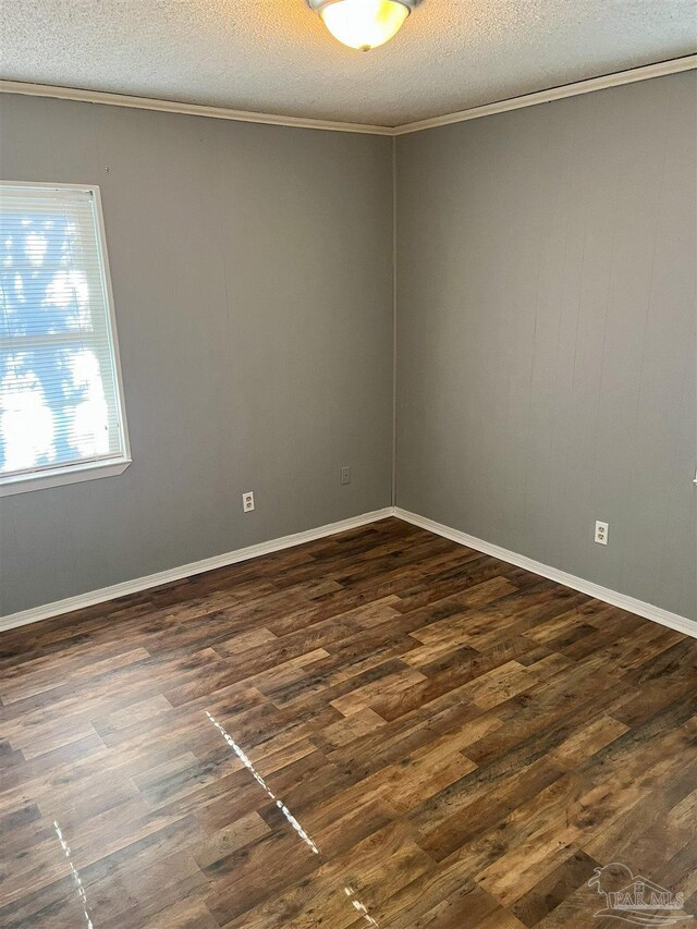 6255 Memphis Ave, Pensacola, FL 32526 - spare room with ornamental molding, a textured ceiling, and dark wood-type flooring
