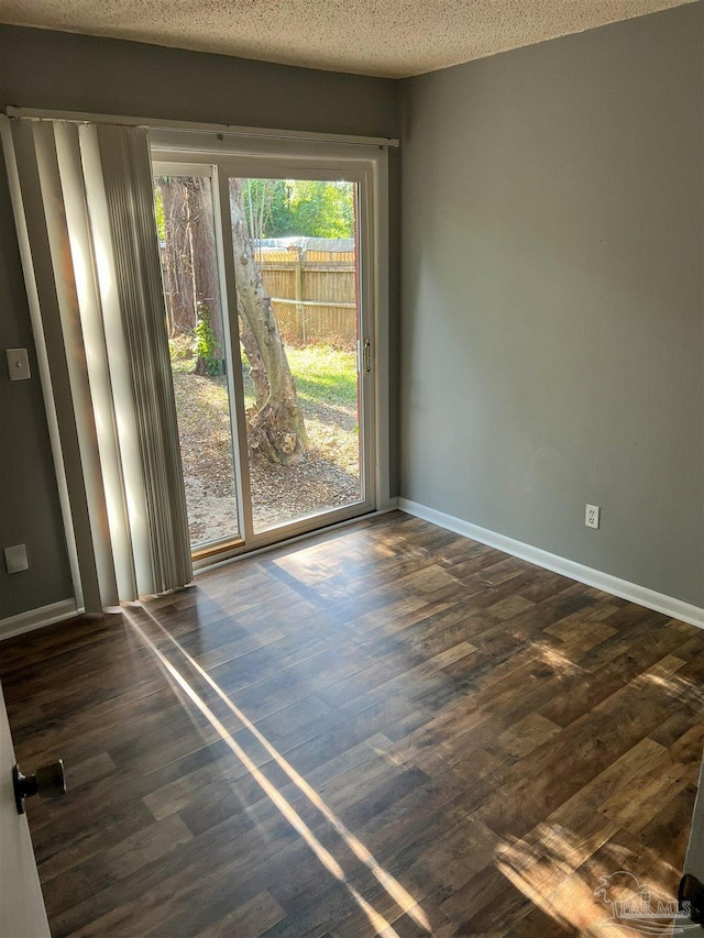 6255 Memphis Ave, Pensacola, FL 32526 - unfurnished room with dark wood finished floors, baseboards, and a textured ceiling