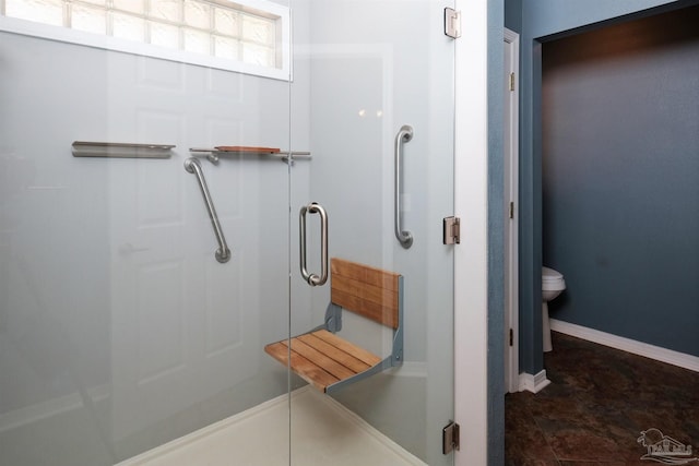 bathroom with toilet and an enclosed shower