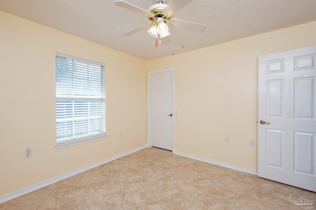 empty room featuring a textured ceiling and ceiling fan