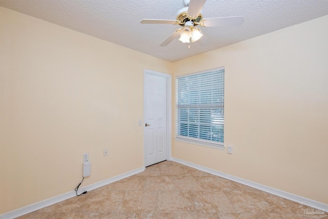 spare room with ceiling fan and a textured ceiling