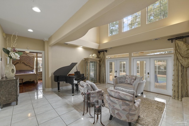 living room featuring french doors, a healthy amount of sunlight, visible vents, and light tile patterned floors