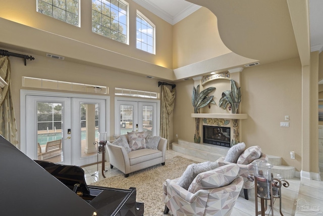 tiled living area featuring a high end fireplace, french doors, visible vents, and crown molding