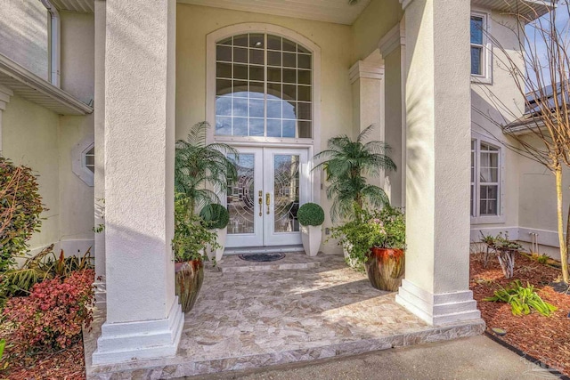 doorway to property with stucco siding and french doors