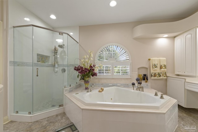 full bathroom with a shower stall, a tub with jets, vaulted ceiling, and recessed lighting