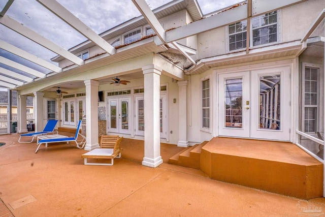 view of patio with a lanai, a ceiling fan, and french doors