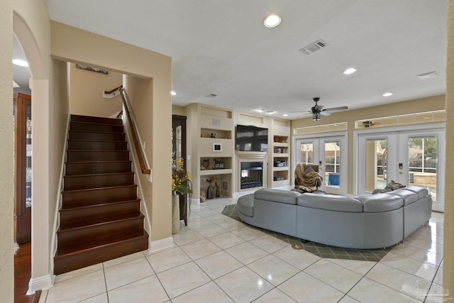 unfurnished living room featuring stairs, french doors, light tile patterned floors, and visible vents