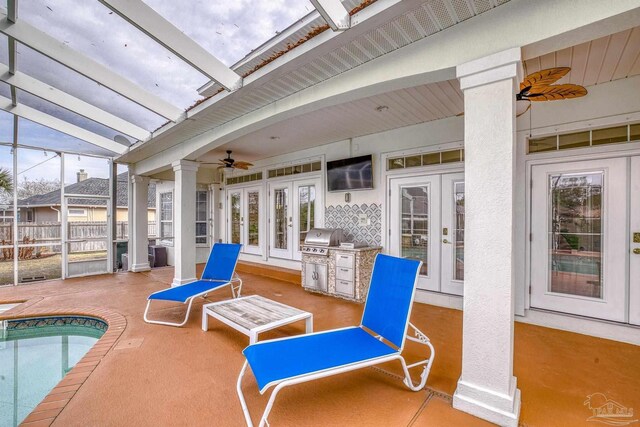 view of patio featuring a lanai, a grill, ceiling fan, and french doors