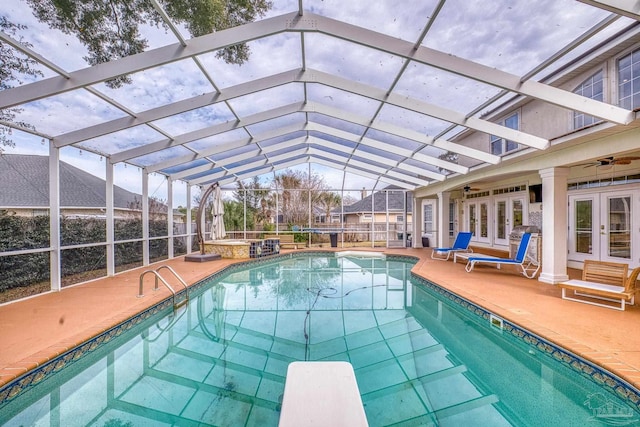 outdoor pool featuring french doors, a patio, a ceiling fan, glass enclosure, and an in ground hot tub