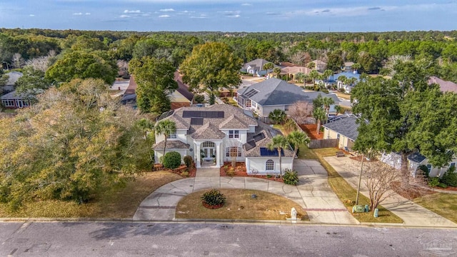 birds eye view of property with a residential view and a wooded view