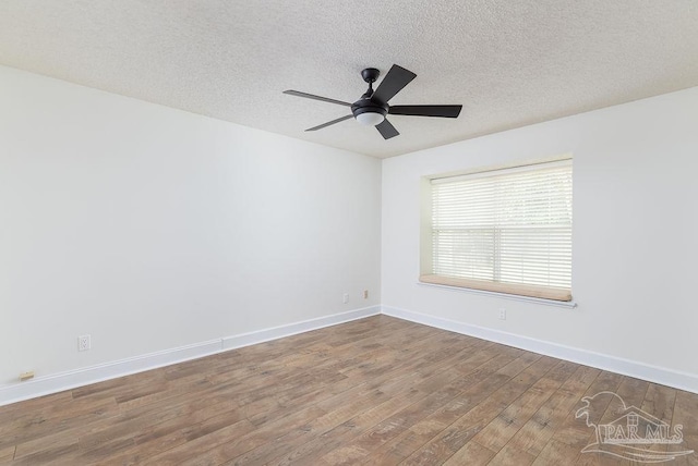 3117 Albert Ct, Pensacola, FL 32504 - empty room with baseboards, a ceiling fan, a textured ceiling, and wood finished floors