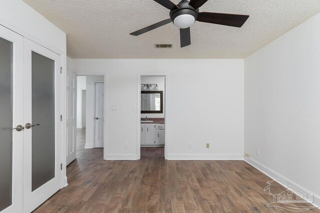 3117 Albert Ct, Pensacola, FL 32504 - unfurnished bedroom featuring visible vents, a sink, a textured ceiling, and wood finished floors