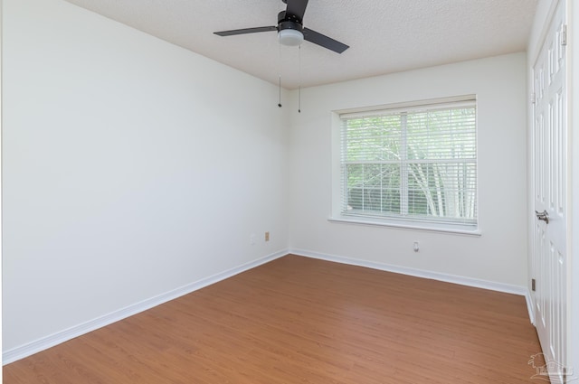 3117 Albert Ct, Pensacola, FL 32504 - empty room featuring a textured ceiling, baseboards, a ceiling fan, and light wood-style flooring