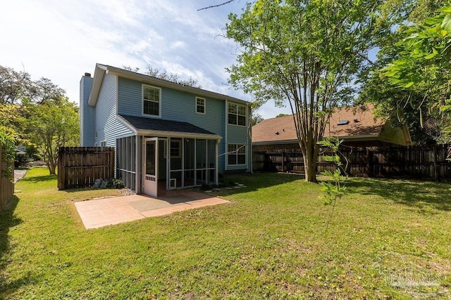 3117 Albert Ct, Pensacola, FL 32504 - back of house featuring a chimney, a lawn, a sunroom, a fenced backyard, and a patio