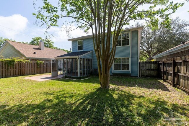 3117 Albert Ct, Pensacola, FL 32504 - back of house with a fenced backyard, a lawn, and a sunroom