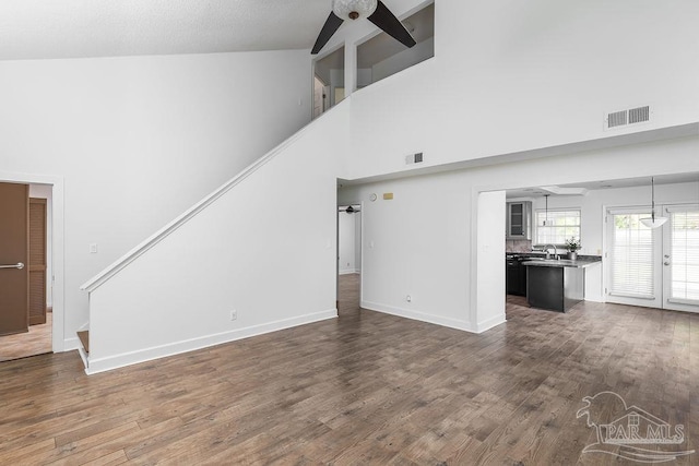 3117 Albert Ct, Pensacola, FL 32504 - unfurnished living room with visible vents, ceiling fan, high vaulted ceiling, and stairway