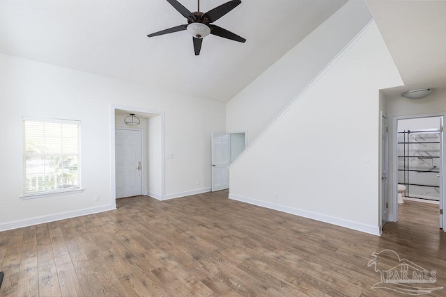 3117 Albert Ct, Pensacola, FL 32504 - unfurnished living room with baseboards, ceiling fan, wood finished floors, and high vaulted ceiling