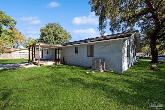 back of house featuring a patio area, central air condition unit, and a yard