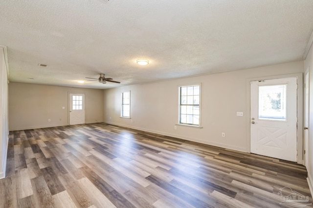 interior space with a textured ceiling, hardwood / wood-style flooring, and ceiling fan