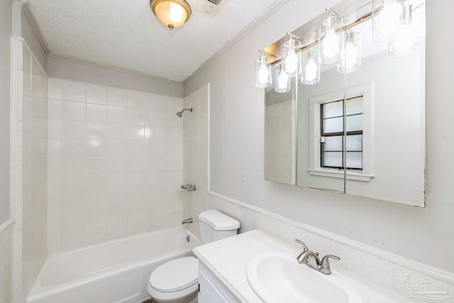 full bathroom featuring vanity, tiled shower / bath combo, a textured ceiling, and toilet