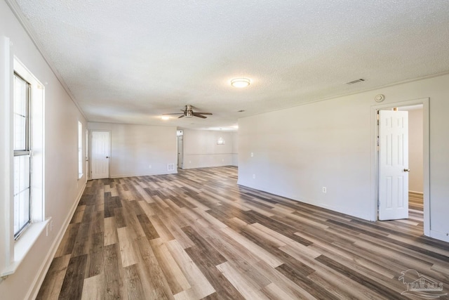 unfurnished living room with wood-type flooring, a textured ceiling, and ceiling fan