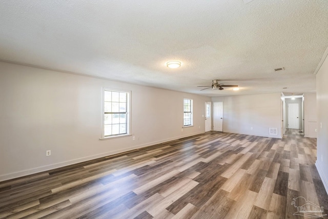 spare room featuring wood-type flooring, a textured ceiling, and ceiling fan