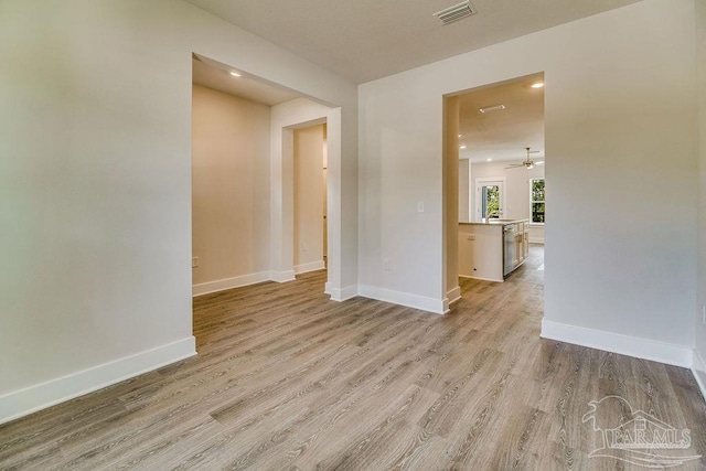 spare room featuring ceiling fan and light wood-type flooring