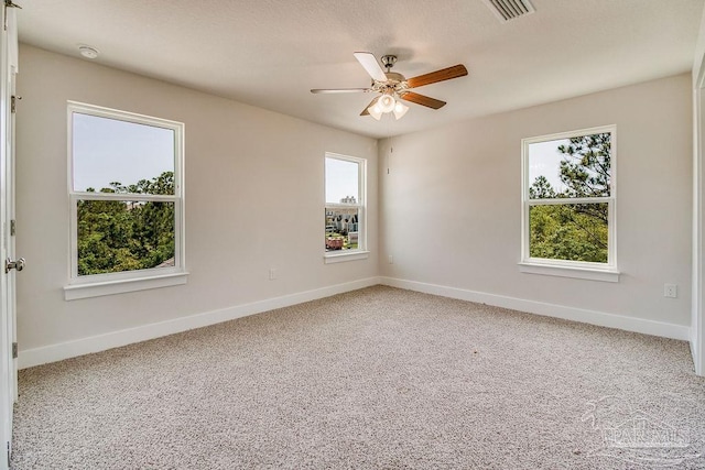 spare room featuring carpet floors and ceiling fan