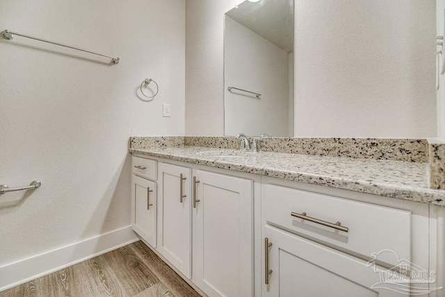 bathroom with hardwood / wood-style floors and vanity