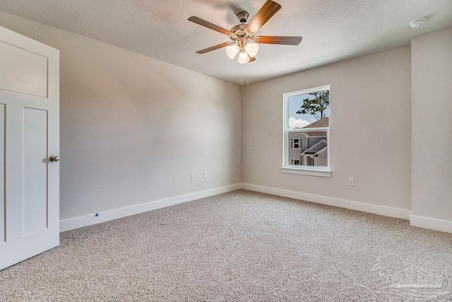 carpeted empty room featuring ceiling fan and a textured ceiling