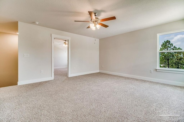 empty room featuring ceiling fan, carpet floors, and a textured ceiling