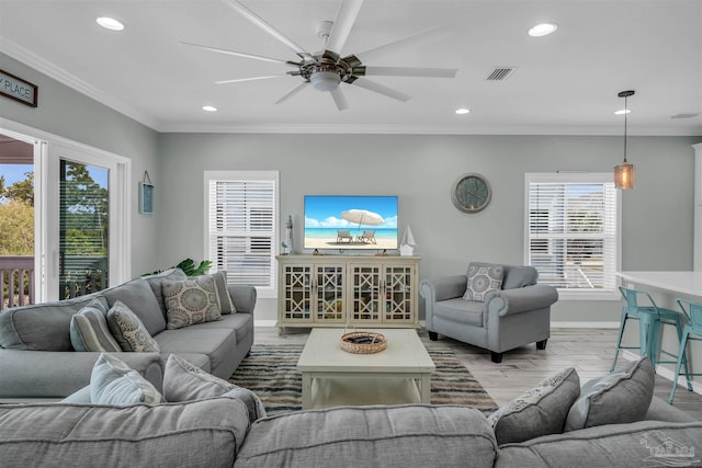 living area with recessed lighting, ceiling fan, baseboards, ornamental molding, and wood finished floors