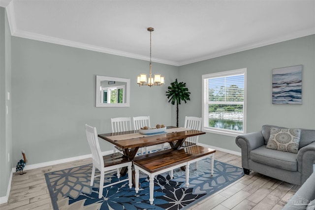 dining room with baseboards, light wood-type flooring, an inviting chandelier, and crown molding