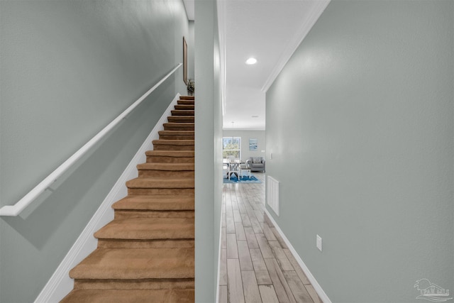 stairway with recessed lighting, wood finished floors, and baseboards