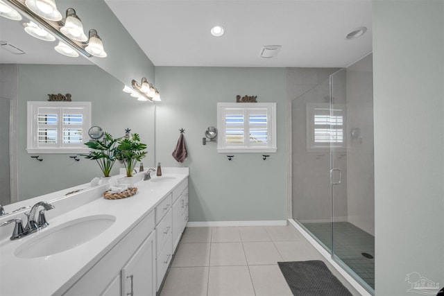 bathroom with tile patterned floors, a wealth of natural light, and a sink