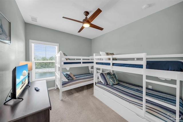 bedroom with baseboards, visible vents, ceiling fan, and carpet flooring