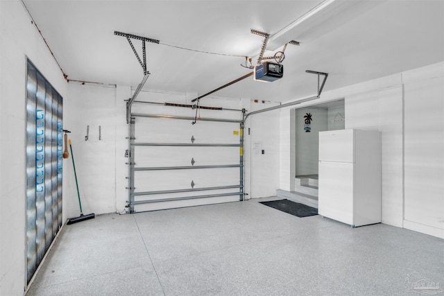 garage with freestanding refrigerator and a garage door opener