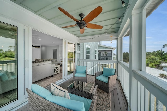 sunroom / solarium with a ceiling fan