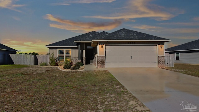 view of front of home featuring a garage and a lawn